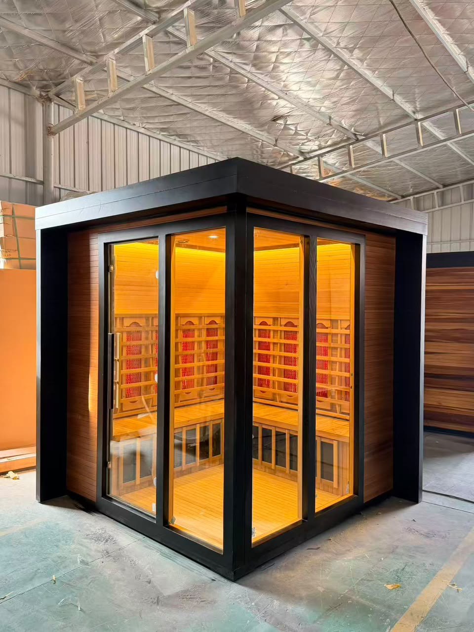 Commercial infrared sauna cabin, black exterior with red cedar interior