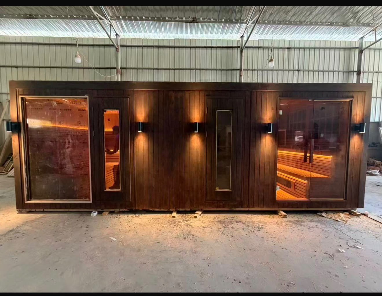 Four-metre commercial traditional sauna with dark timber exterior and glazed sections