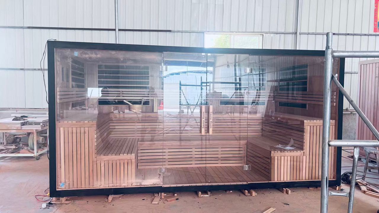 Commercial traditional sauna with full glass front and red cedar benches